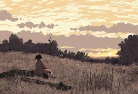 Un homme contemple le coucher de soleil assis dans un champ.