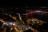Photo nocturne aérienne de Blois, prise au niveau du Château, en direction du sud-est. Au premier plan, les bulles du festival Des Lyres d’hiver rayonnent sur la place Louis 12. Au second plan, la sombre Loire tranche avec le reste des rues éclairées. Le pont Jacques-Gabriel est illuminé en rouge. À l’arrière-plan, les lumières de Vineuil.